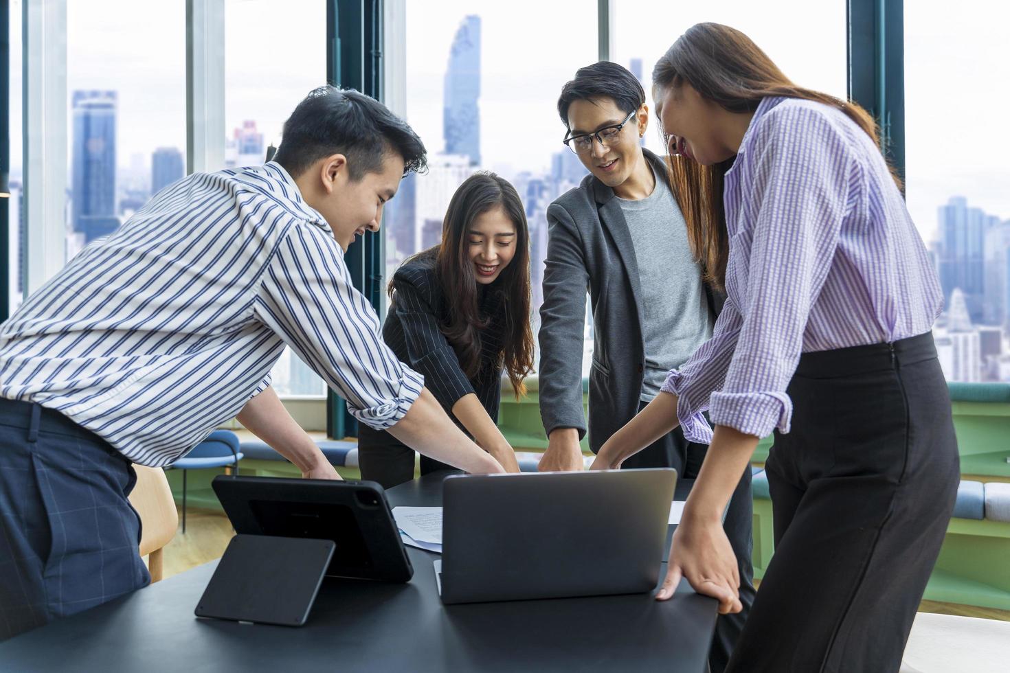 Team of young Asian entrepreneur have small team meeting for upcoming project for marketing and sale management with skyscraper view for business startup and education concept photo