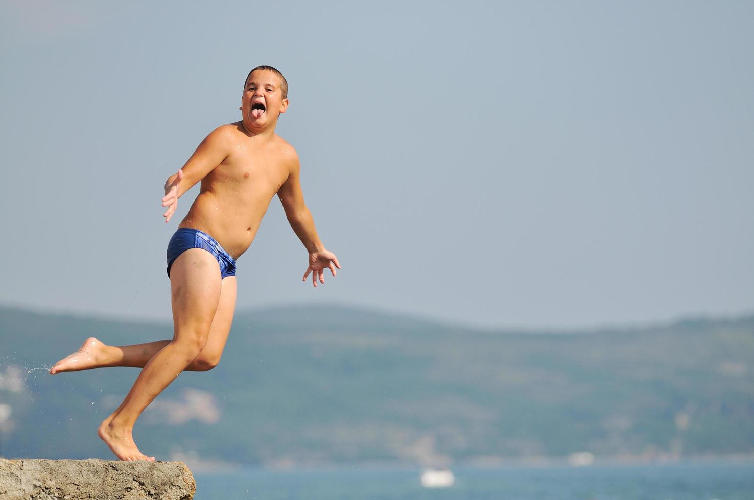 boy jump sea photo