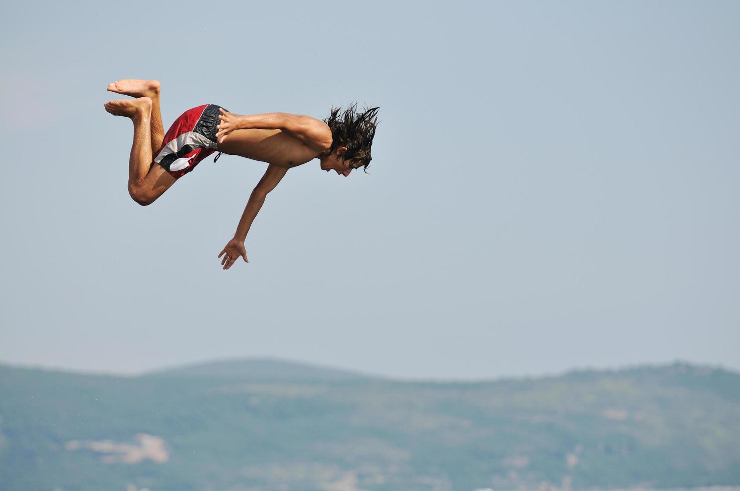 boy jump sea photo