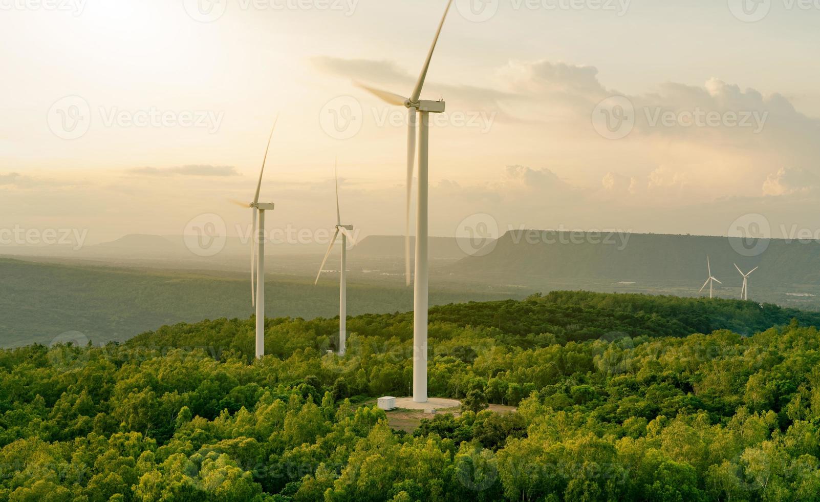 Wind energy. Wind power. Sustainable, renewable energy. Wind turbines generate electricity. Windmill farm on mountain with sunset sky. Green technology. Renewable resource. Sustainable development. photo