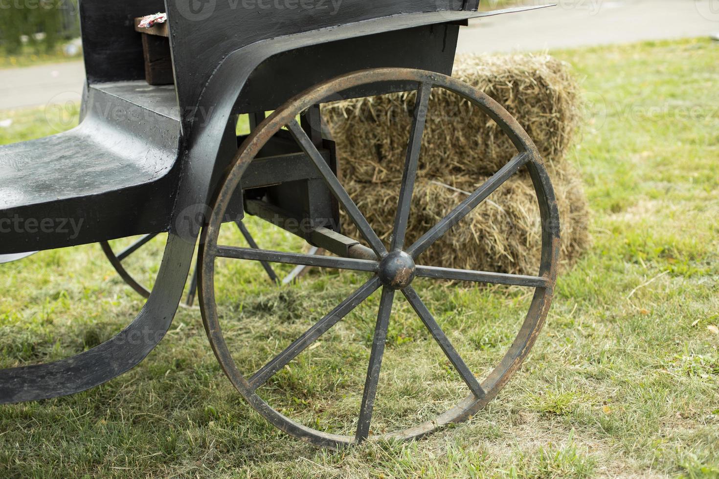 Vintage wheel. Large carriage wheel. Black carriage of bygone era. Vintage transport. photo