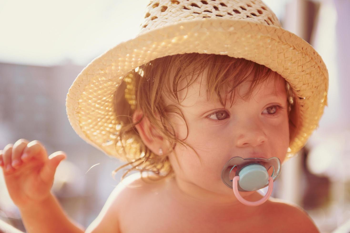 tired little girl resting on sunbed photo