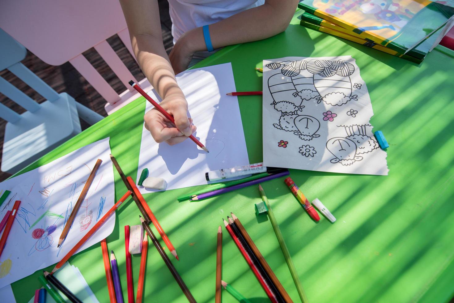 closeup of hands drawing a colorful pictures photo