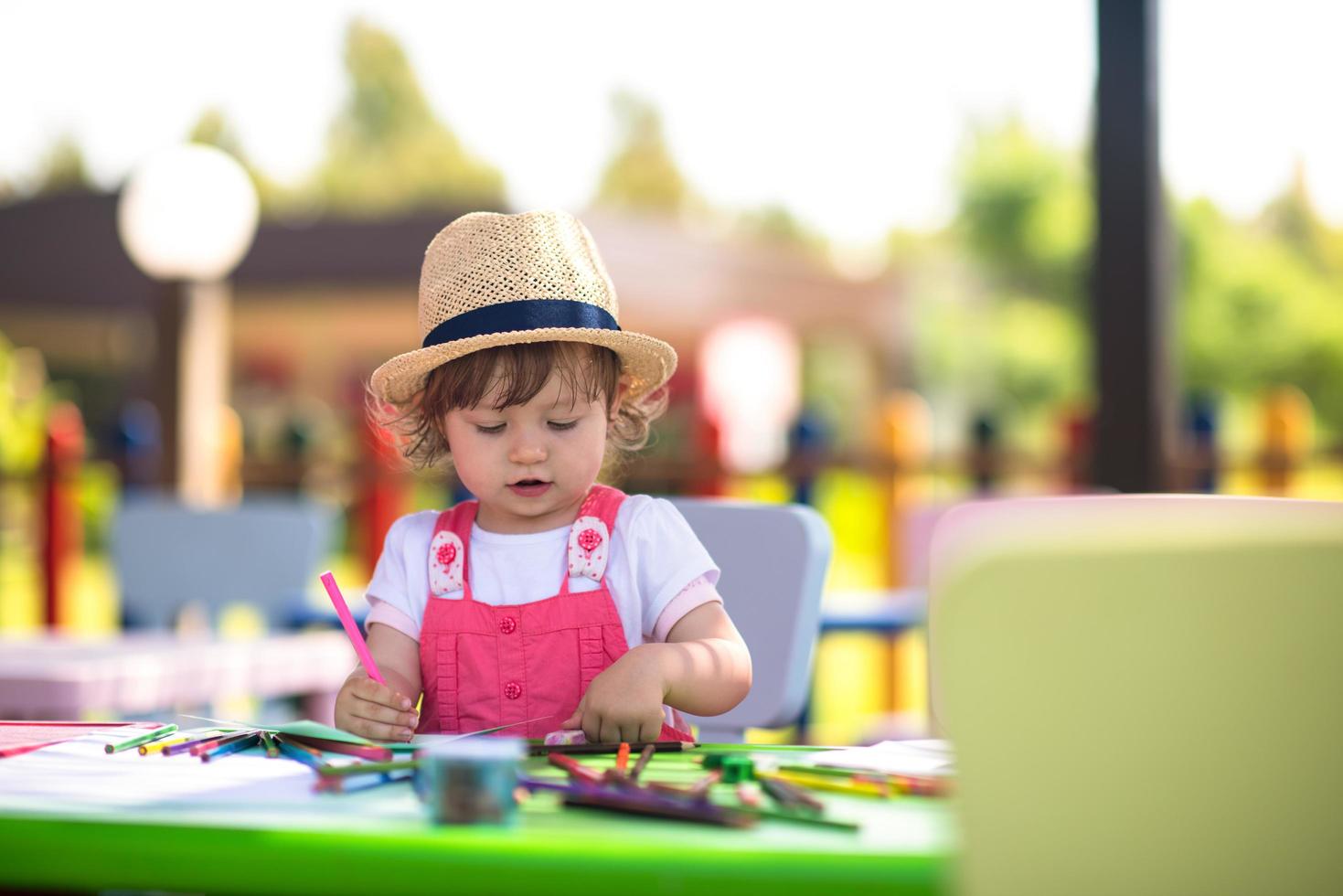 little girl drawing a colorful pictures photo