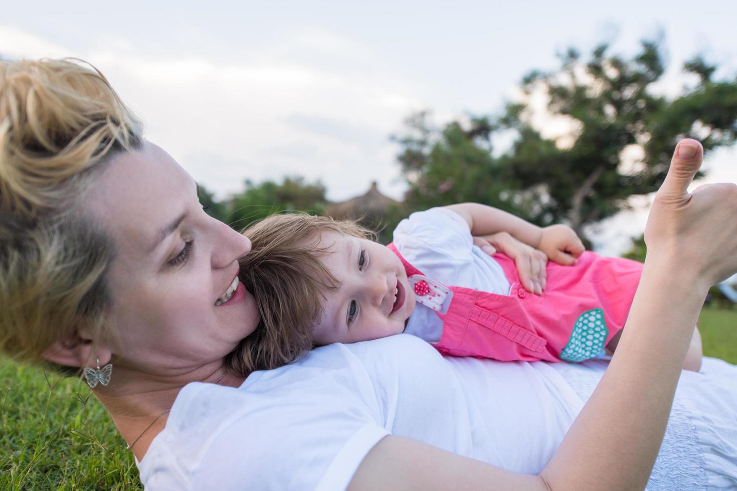 mother and little daughter playing at backyard photo