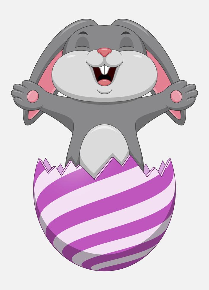 Easter bunny inside a cracked easter egg isolated on white background vector