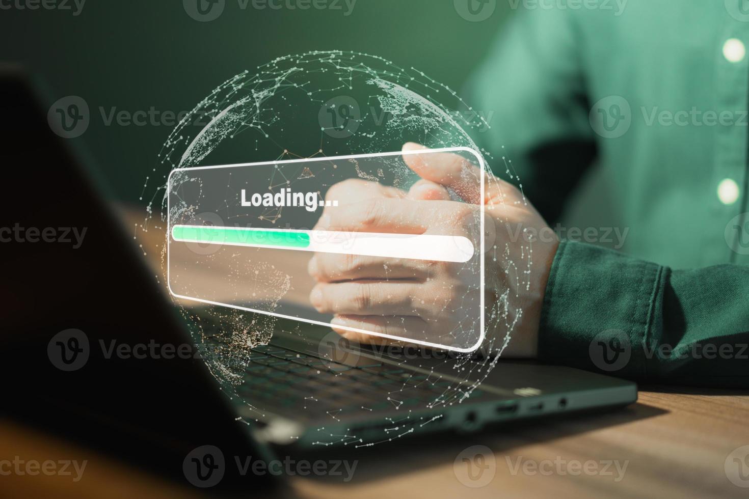 Man using laptop for download and waiting to loading digital business data form website, concept of waiting for load of loading bar. photo