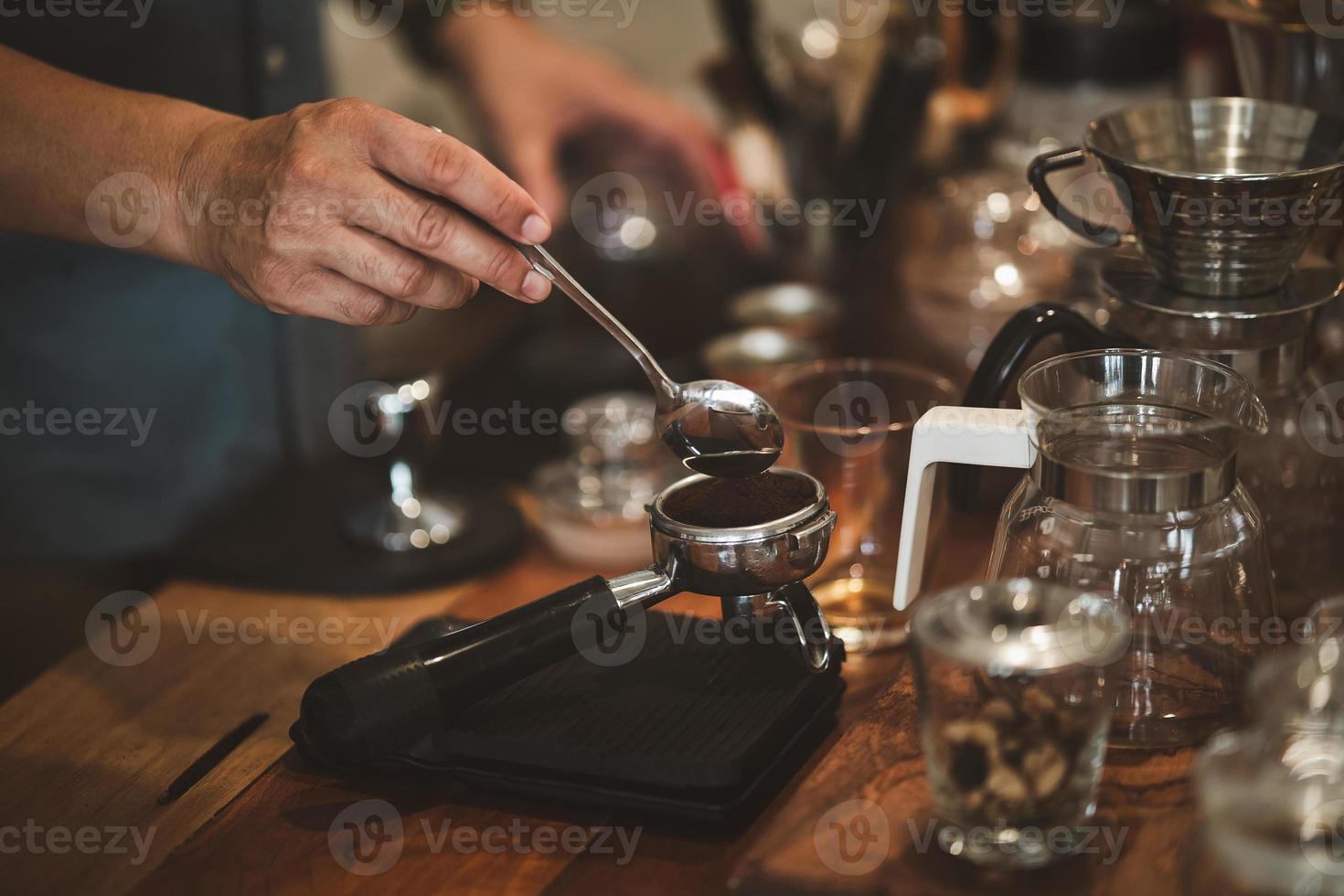 Barista cafe making coffee preparation service concept in restaurant. Close up hand barista making fresh coffee with coffee machine in the cafe. Making fresh coffee espresso. photo