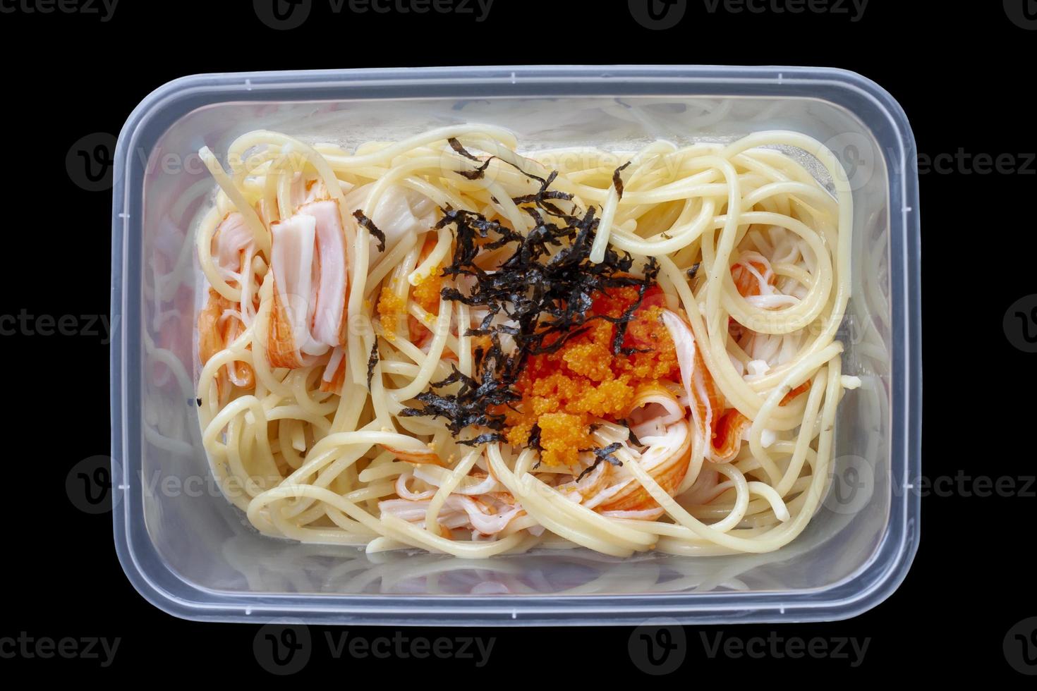 Top view of Spaghetti Creamy Crab Stick and Tobiko in plastic box for delivery at home isolated on black background included clipping path. photo