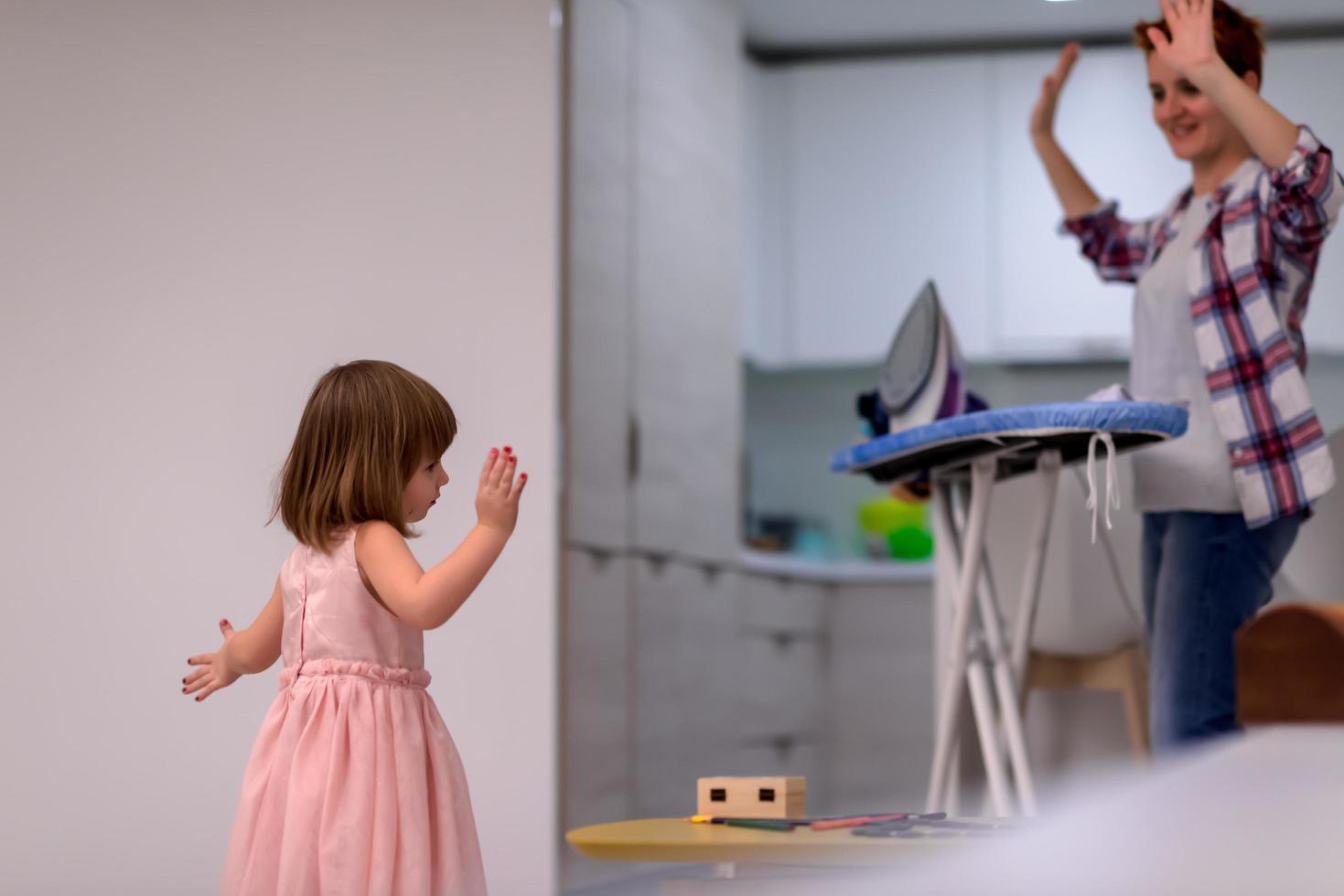 mother and little daughter spending time together at home photo