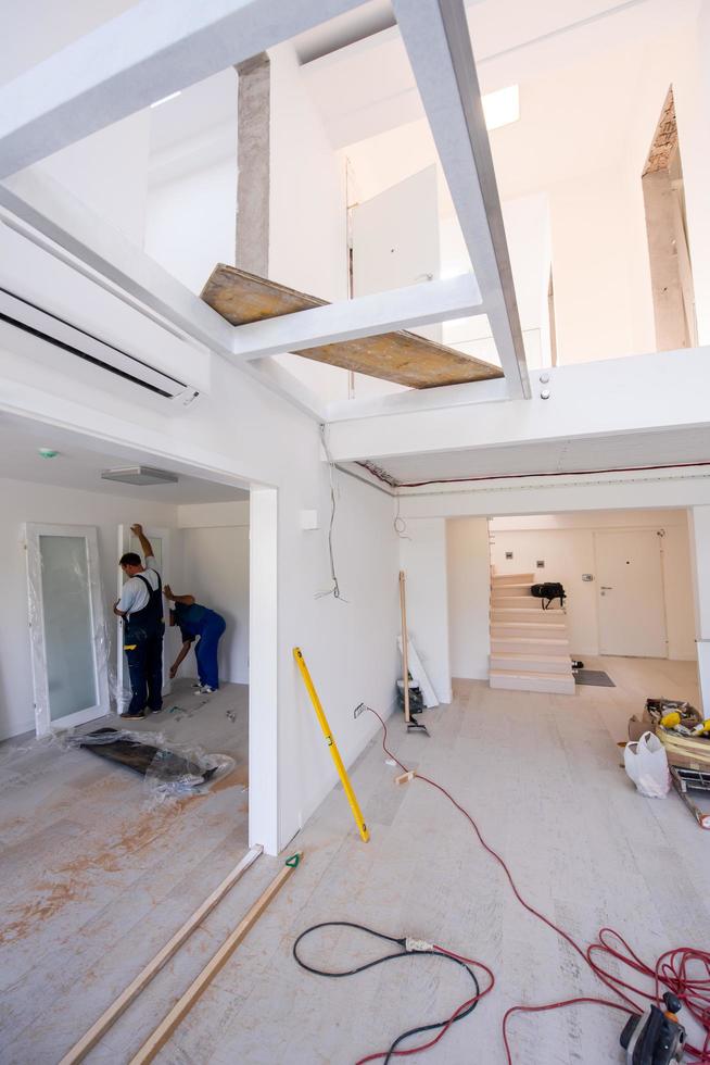 Sweden, 2022 - carpenters installing glass door with a wooden frame photo