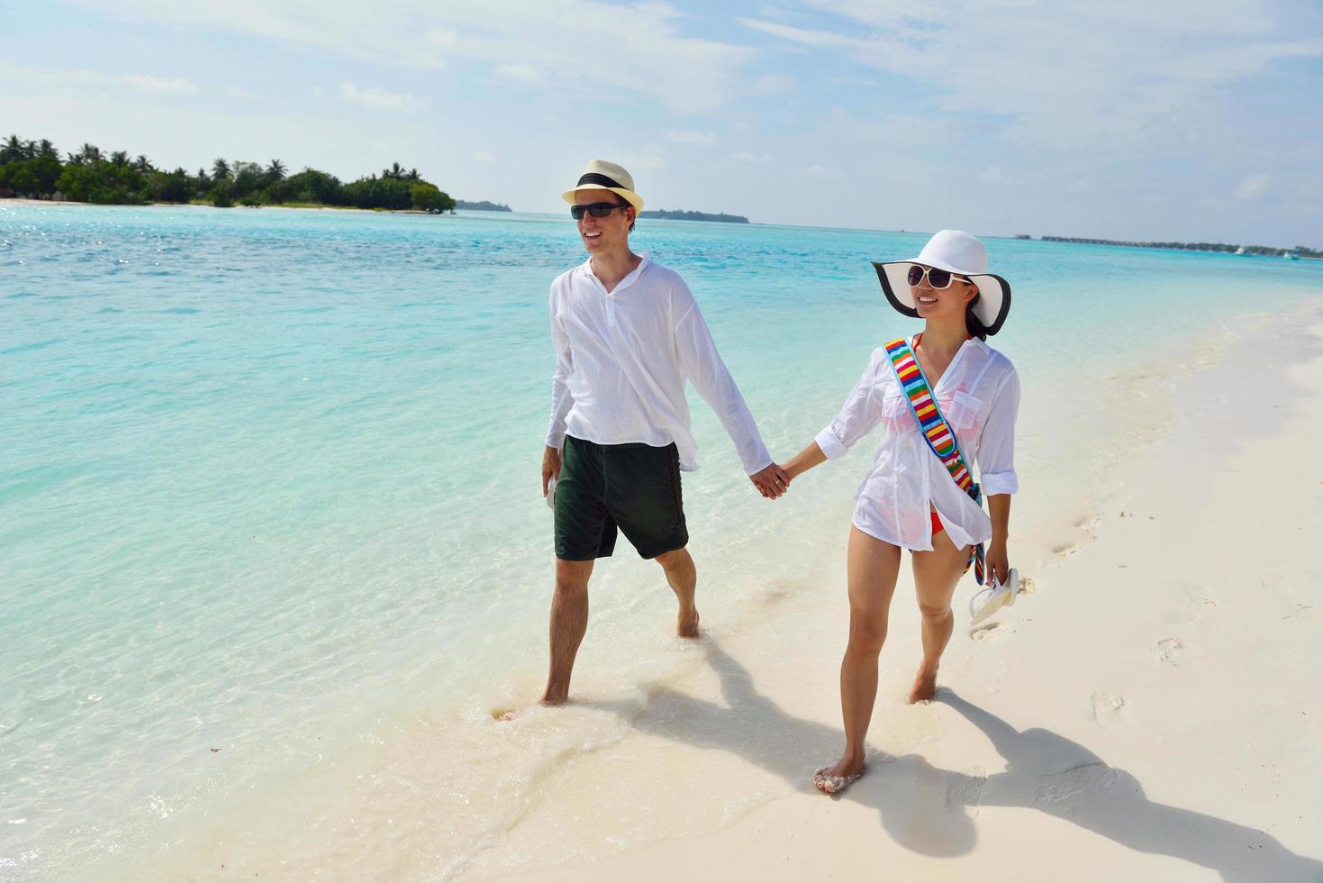 happy young couple have fun on beach photo