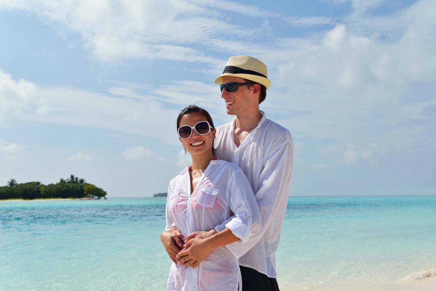 happy young couple have fun on beach photo