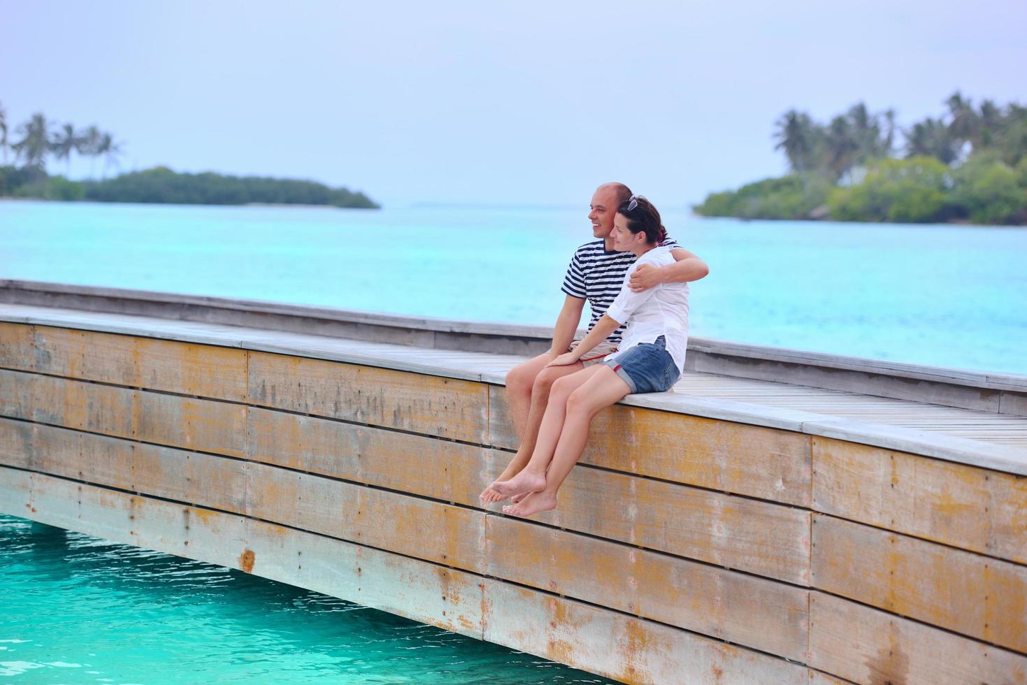 happy young couple have fun on beach photo