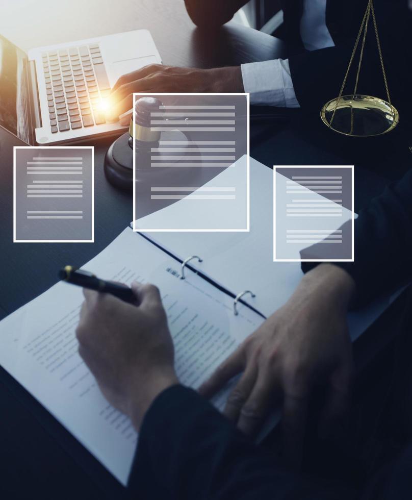 Justice and law concept.Male judge in a courtroom with the gavel, working with, computer and docking keyboard, eyeglasses, on table in morning light photo