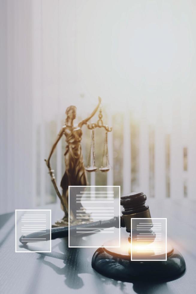 Justice and law concept.Male judge in a courtroom with the gavel, working with, computer and docking keyboard, eyeglasses, on table in morning light photo