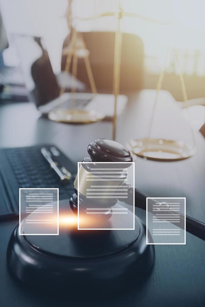 Justice and law concept.Male judge in a courtroom with the gavel, working with, computer and docking keyboard, eyeglasses, on table in morning light photo