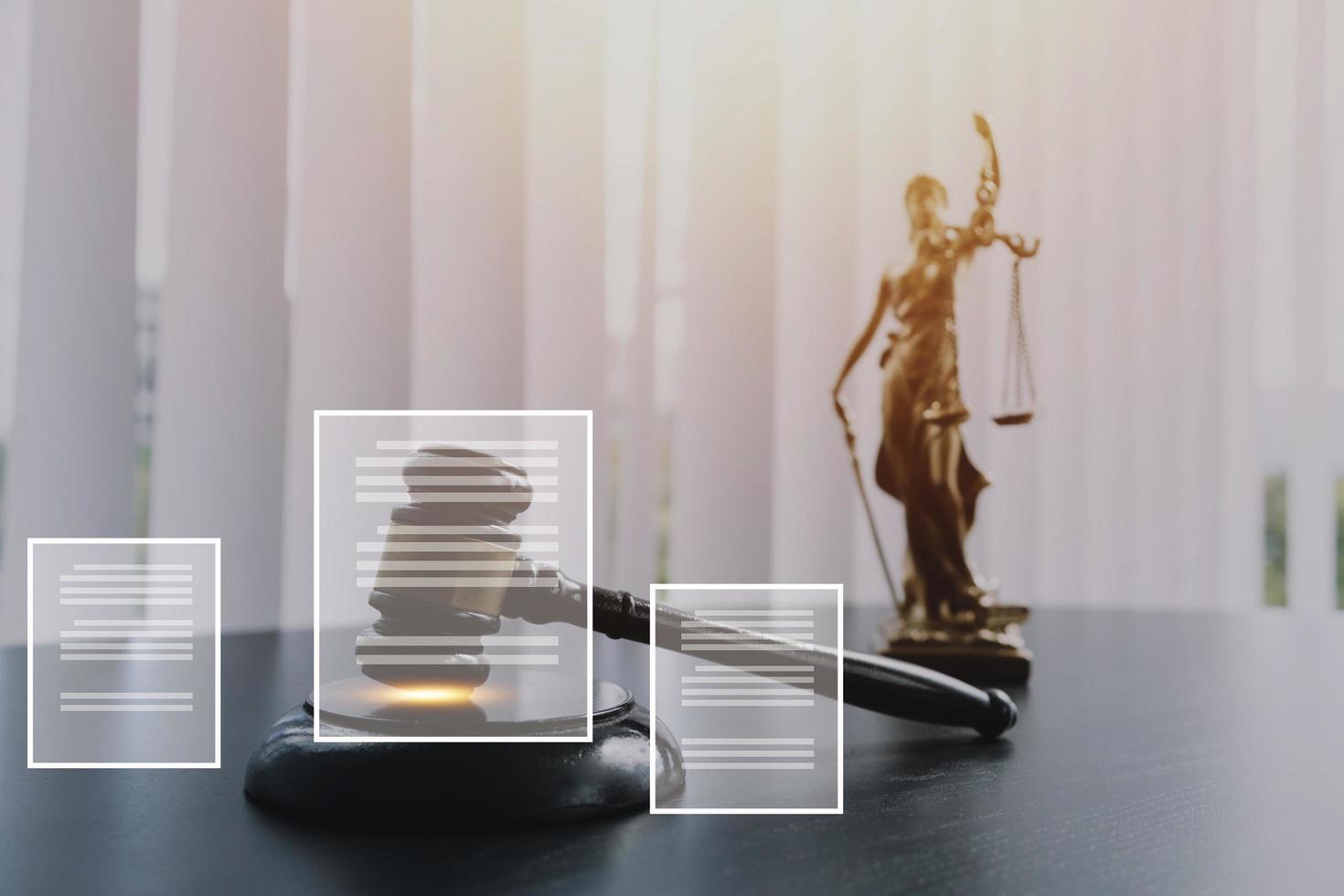 Justice and law concept.Male judge in a courtroom with the gavel, working with, computer and docking keyboard, eyeglasses, on table in morning light photo