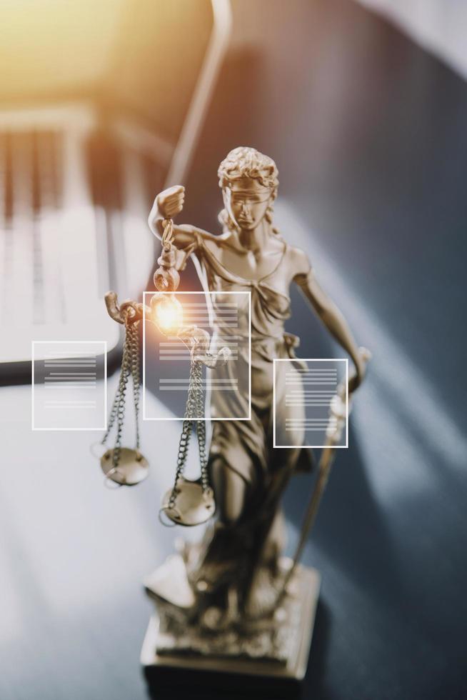 Justice and law concept.Male judge in a courtroom with the gavel, working with, computer and docking keyboard, eyeglasses, on table in morning light photo