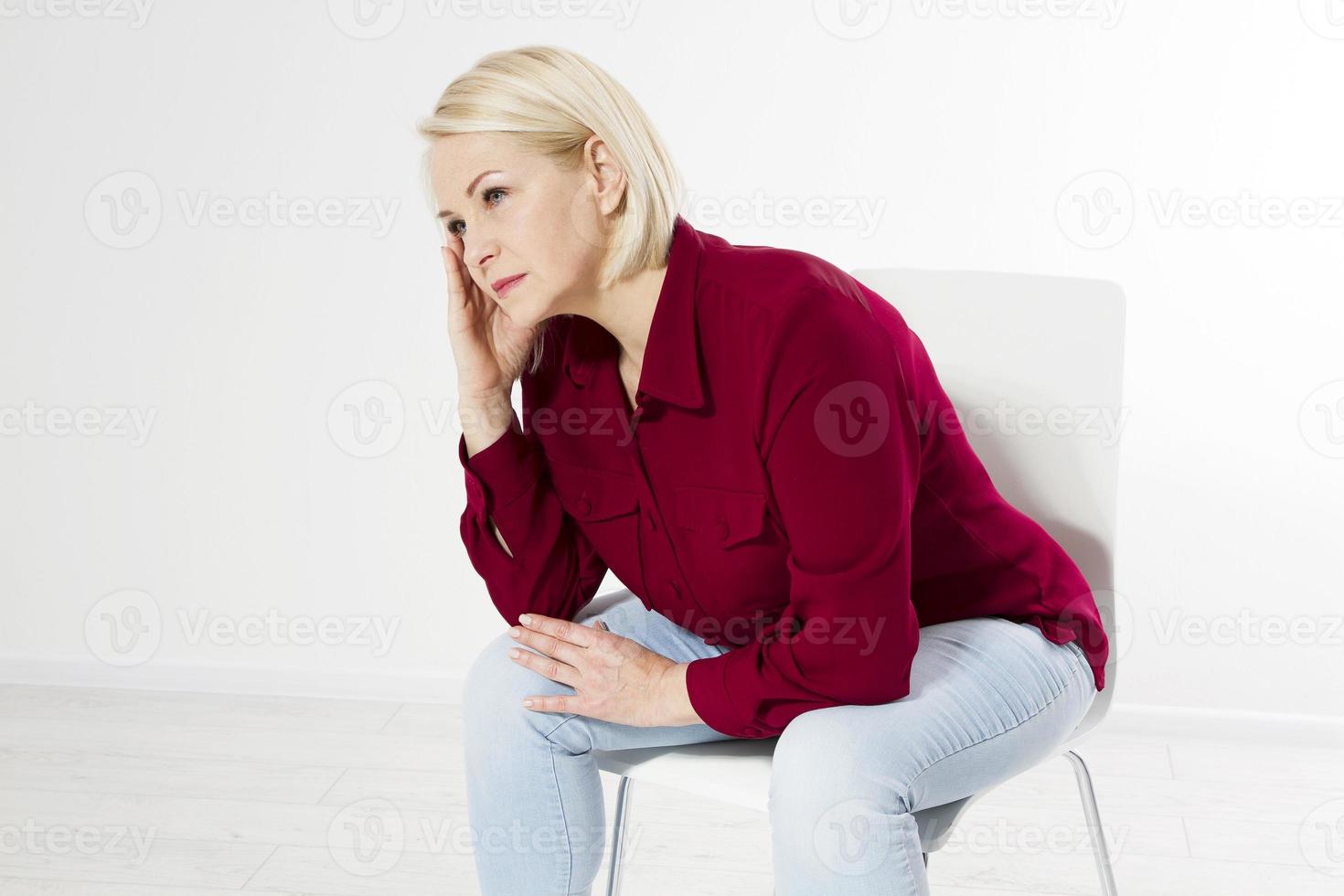 woman with headache sitting on a chair photo