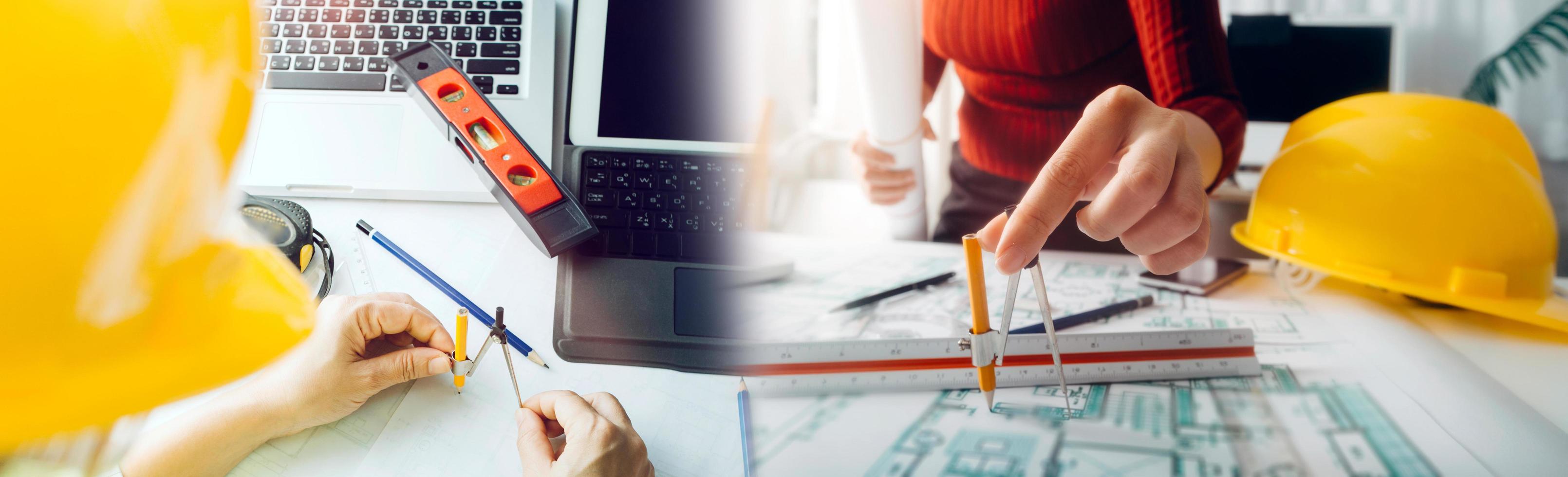 Two colleagues discussing data working and tablet, laptop with on on architectural project at construction site at desk in office photo