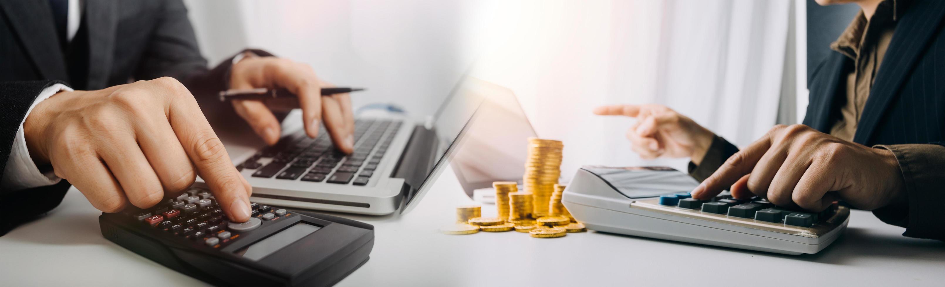 Business accounting concept, Business man using calculator with computer laptop, budget and loan paper in office. photo