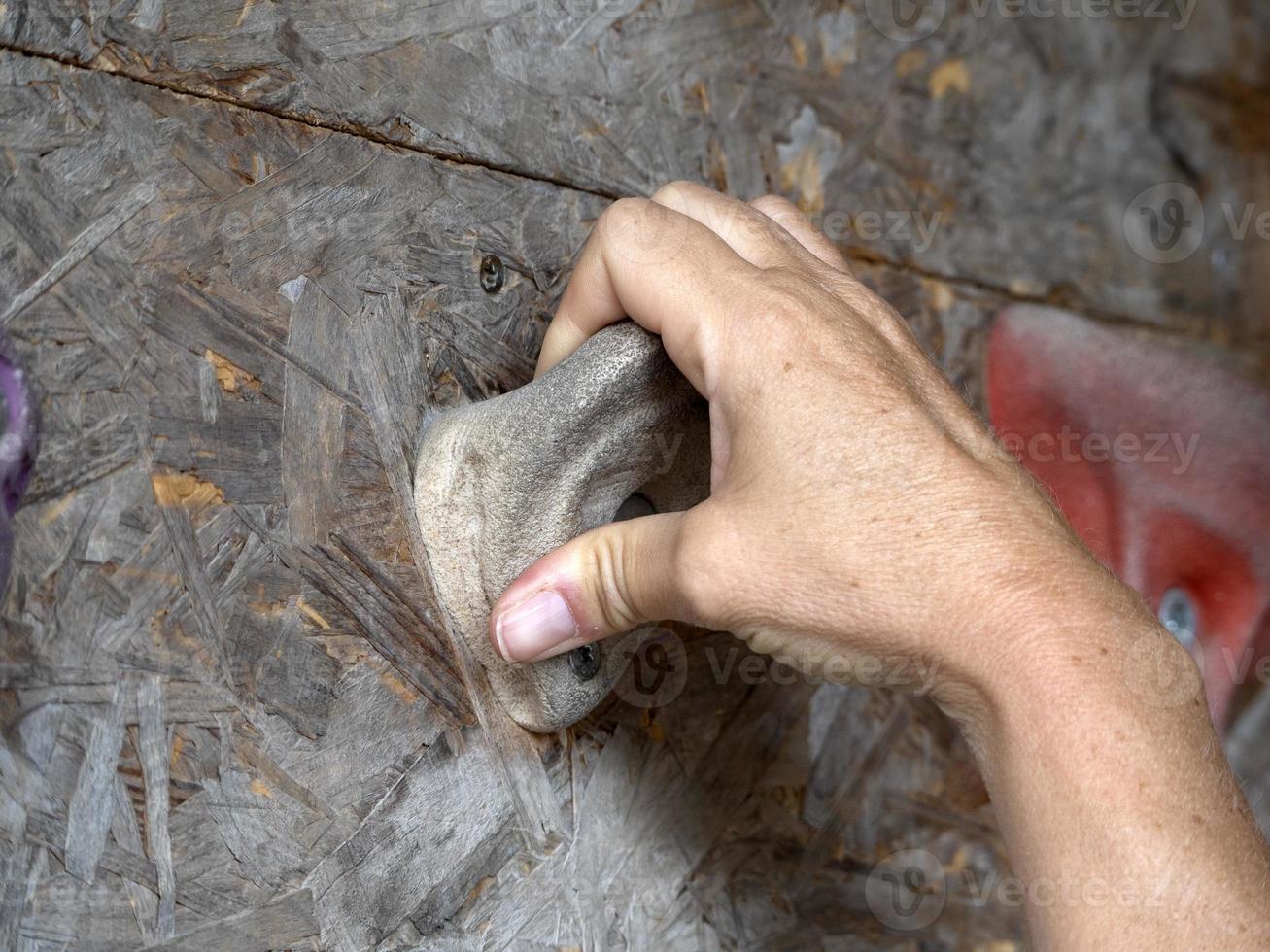 woman hand on Climbing training wall close up photo