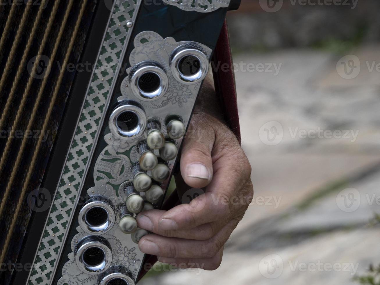 Hands playing accordion detail photo