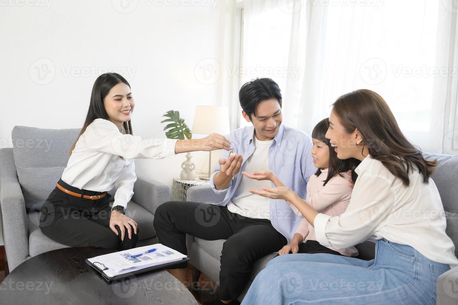 Female real estate agent explaining about the house option and offering promotions to family, Mortgage, loan, property and insurance concept. photo