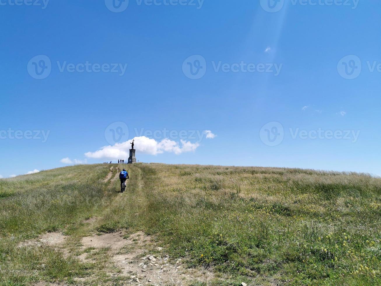 Bikers and Christ statue on Giarolo Mountain top photo