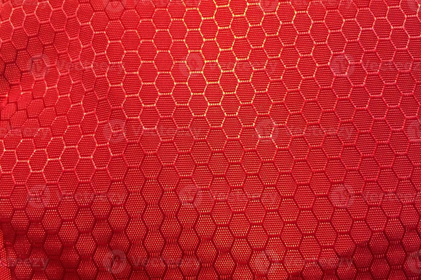 hexagonal red synthetic fabric pattern background photo