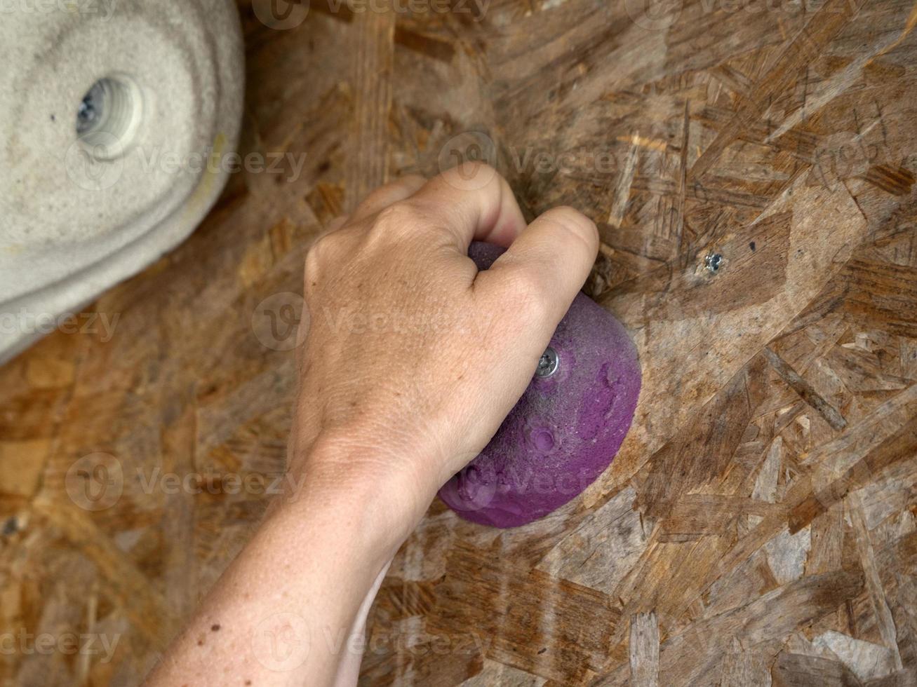 woman hand on Climbing training wall close up photo