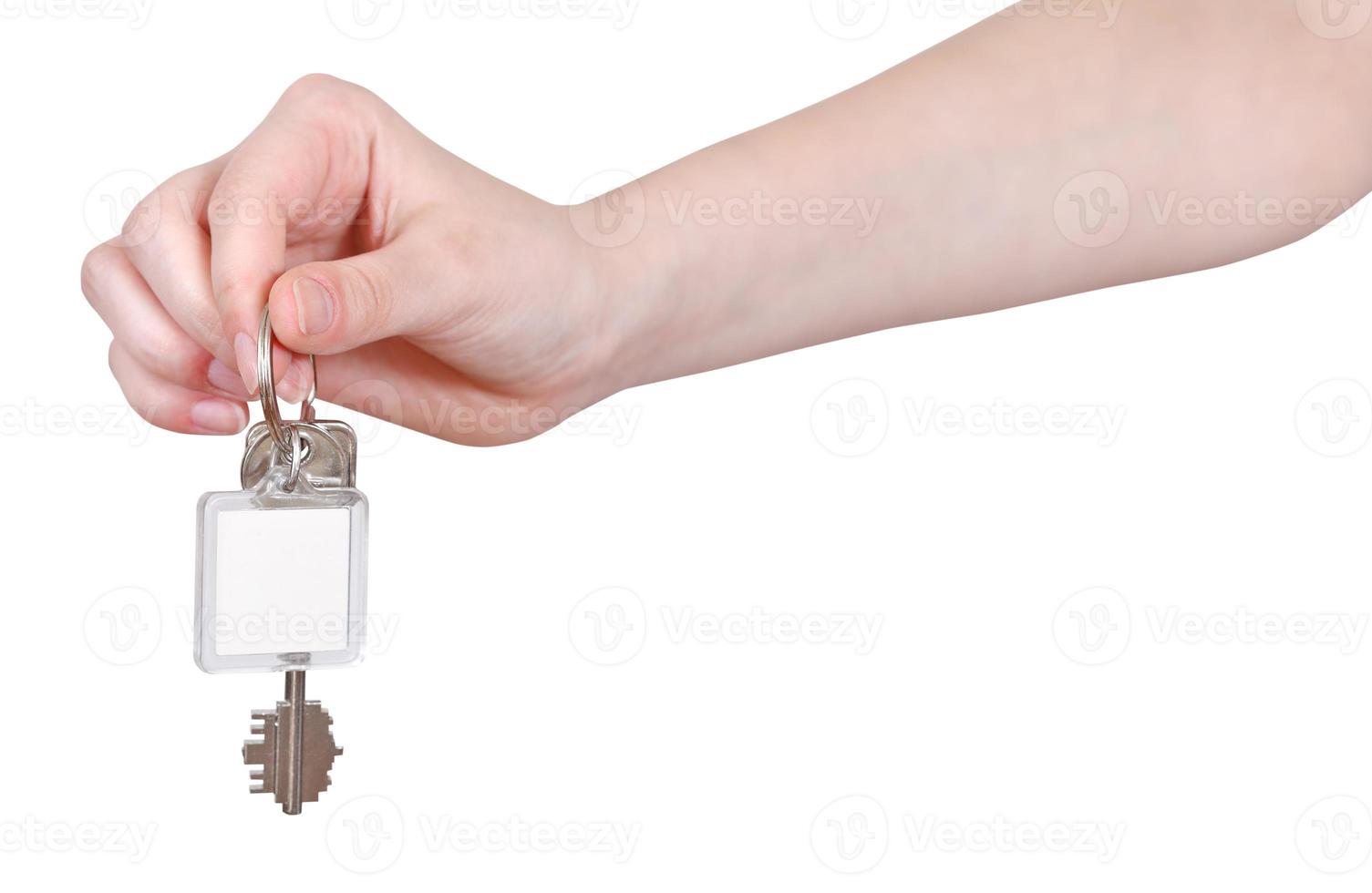 hand with blank key fob isolated on white photo