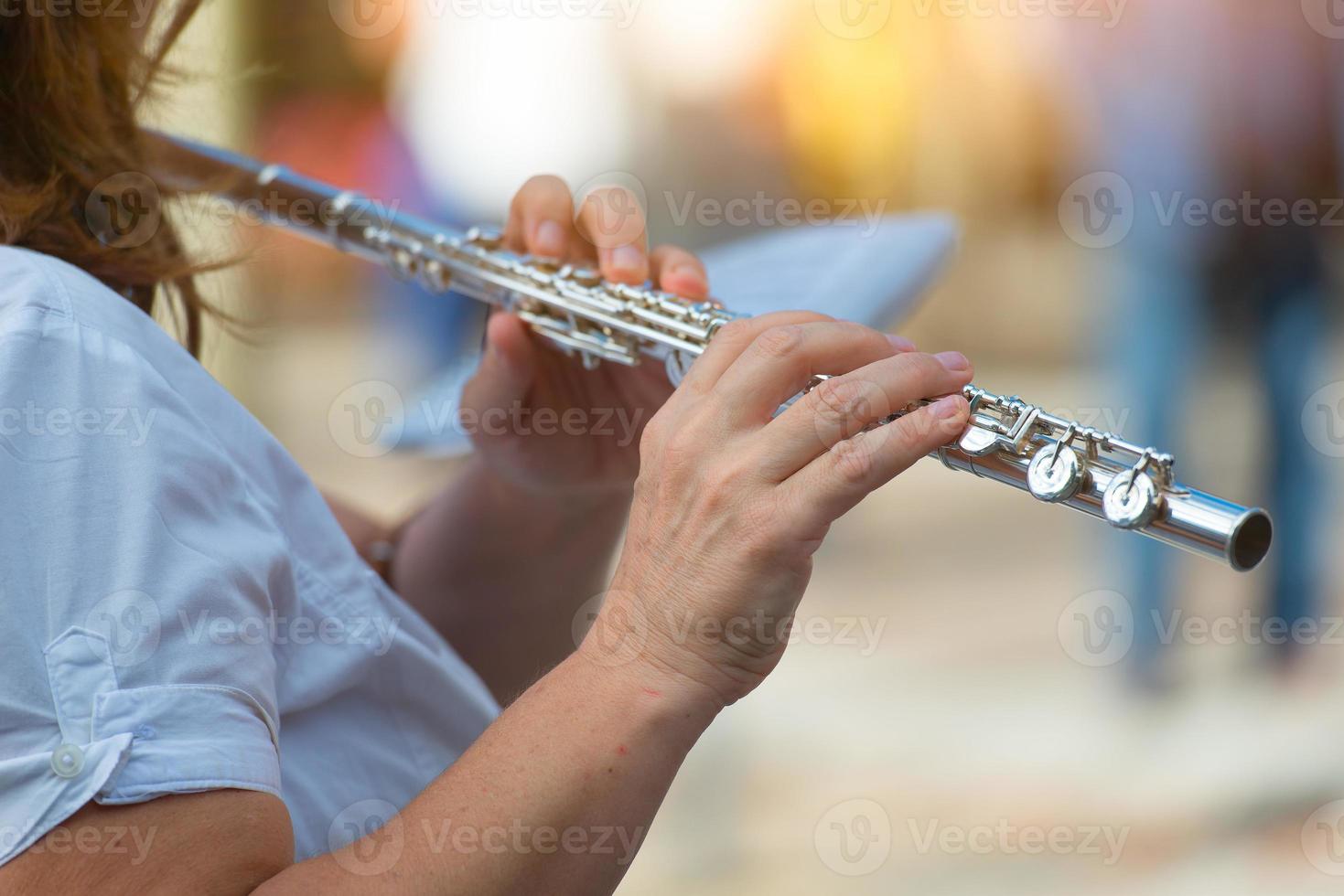 Transverse flute played by a girl photo