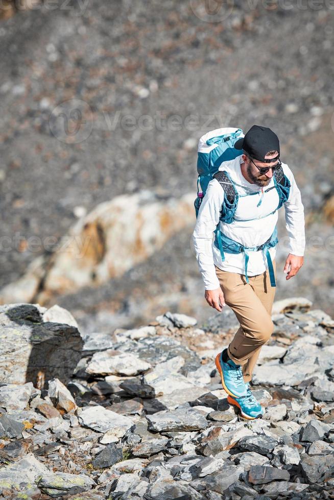 Man walks among. boulders in the mountains photo