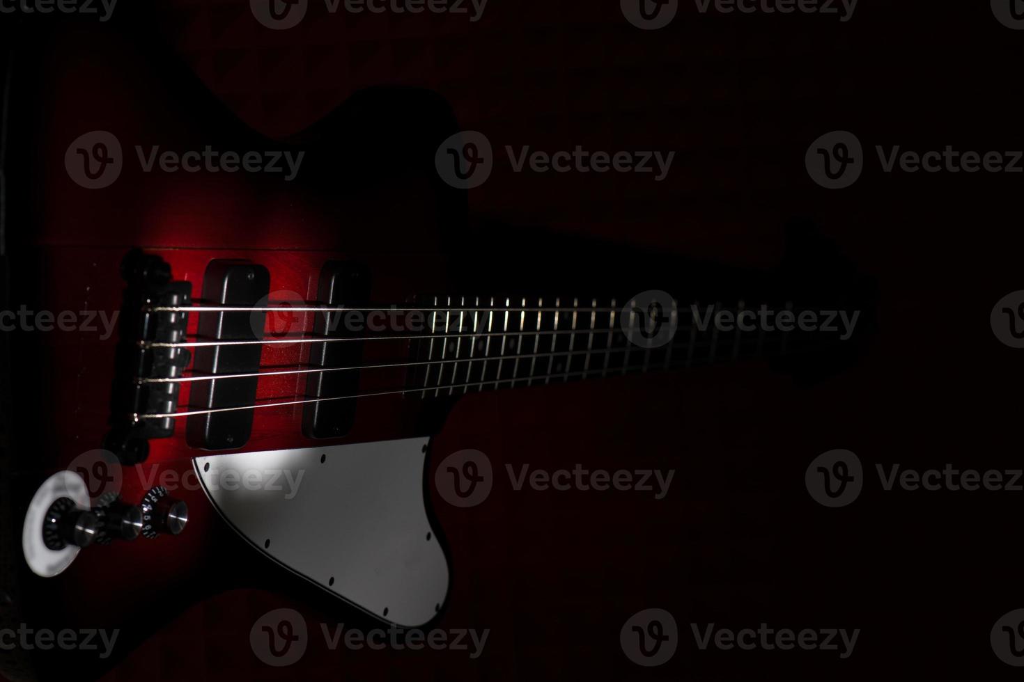 Vintage style electric bass on black background photo