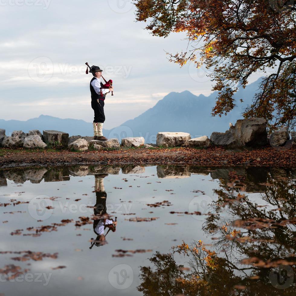 Bergamo player Bagpipe is reflected in a pool of water photo