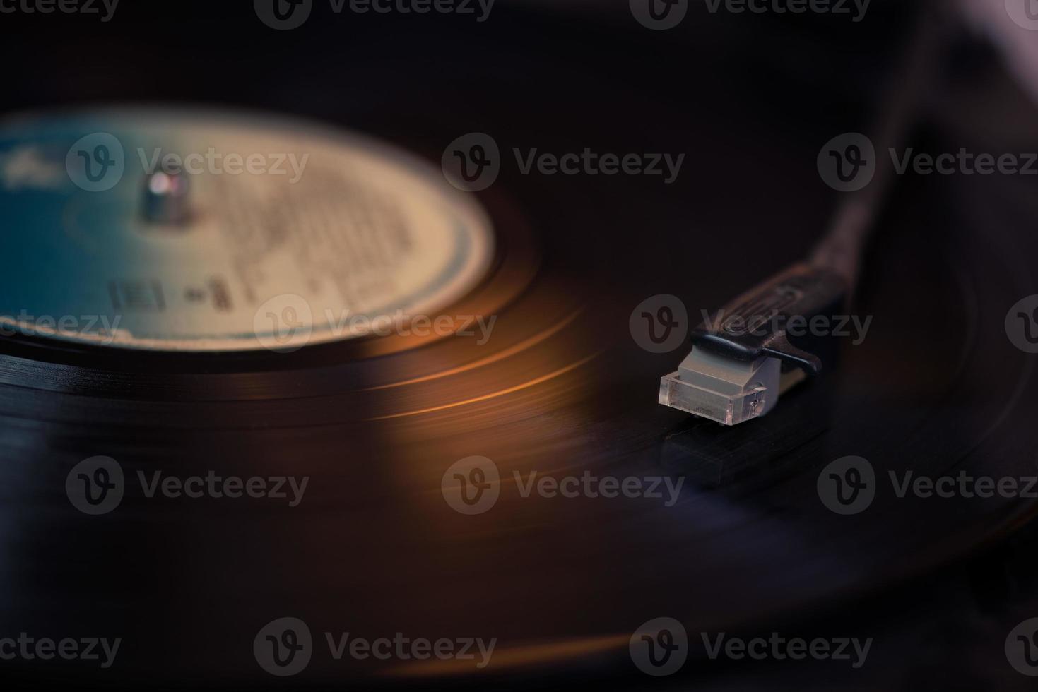 Vintage record player stylus on a rotating disc photo