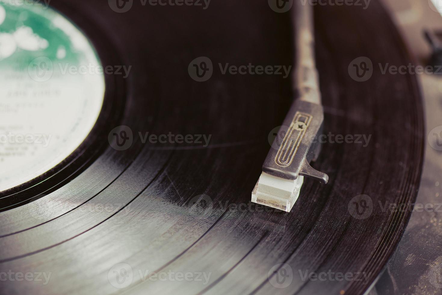 Vintahe record player stylus on a rotating disc photo