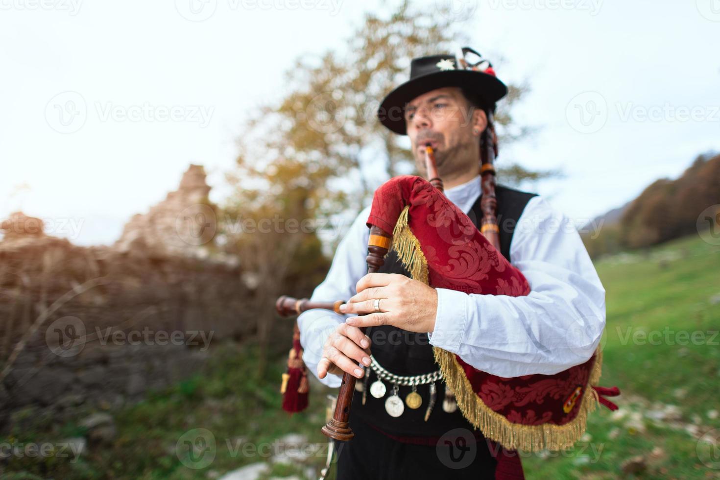 Typical player in traditional bergamo bagpipe from the alpine valleys of northern Italy photo