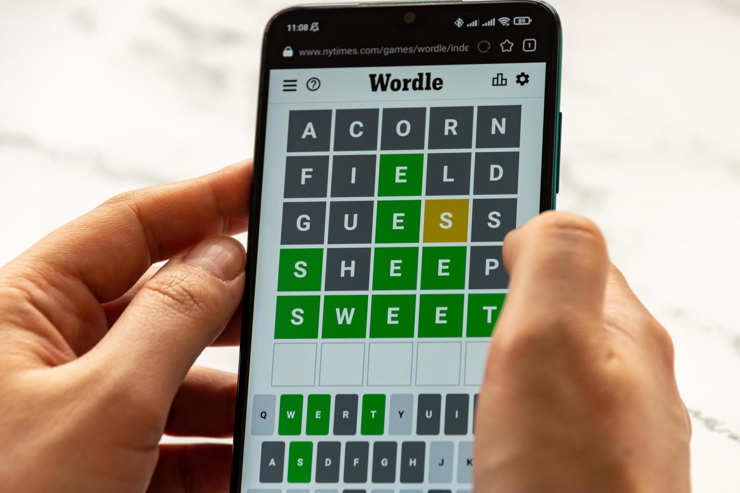 Bucharest, Romania, 2022 - A man plays the WORDLE game photo