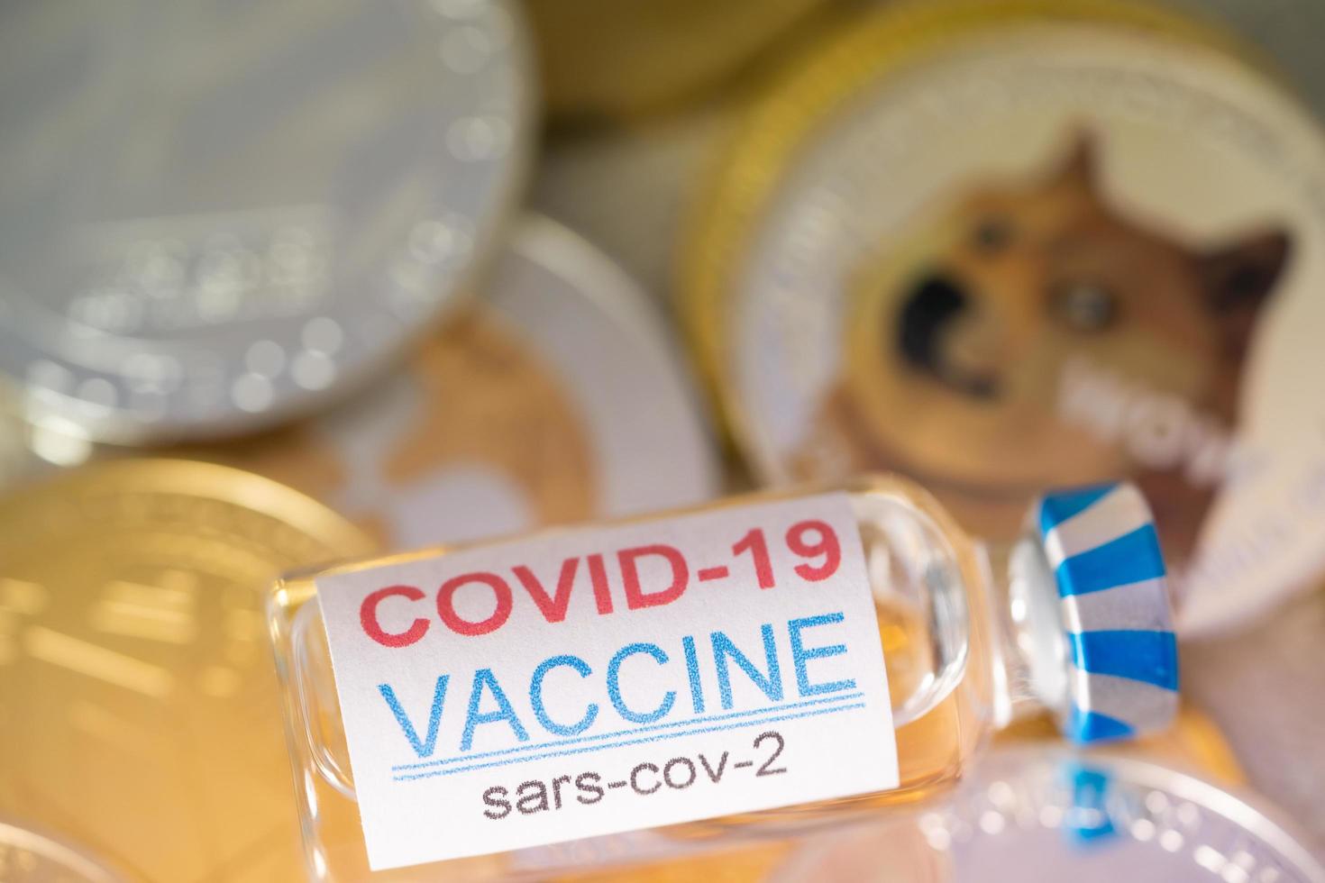 Ampoules Vaccine Covid 19 coronavirus on group of Dogecoin DOGE included with Cryptocurrency coin bitcoin, Ethereum ETH, Binance Coin symbol Virtual blockchain technology future is money concept. photo