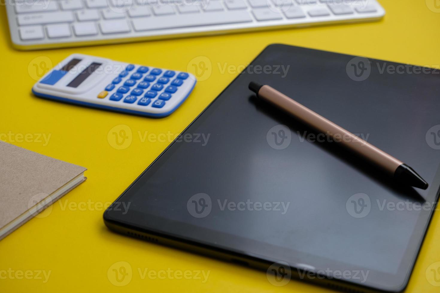 Blank tablet screen while typing on a keyboard, as well as a screen mockup for further customization, can be used for a variety of purposes. area for copying photo