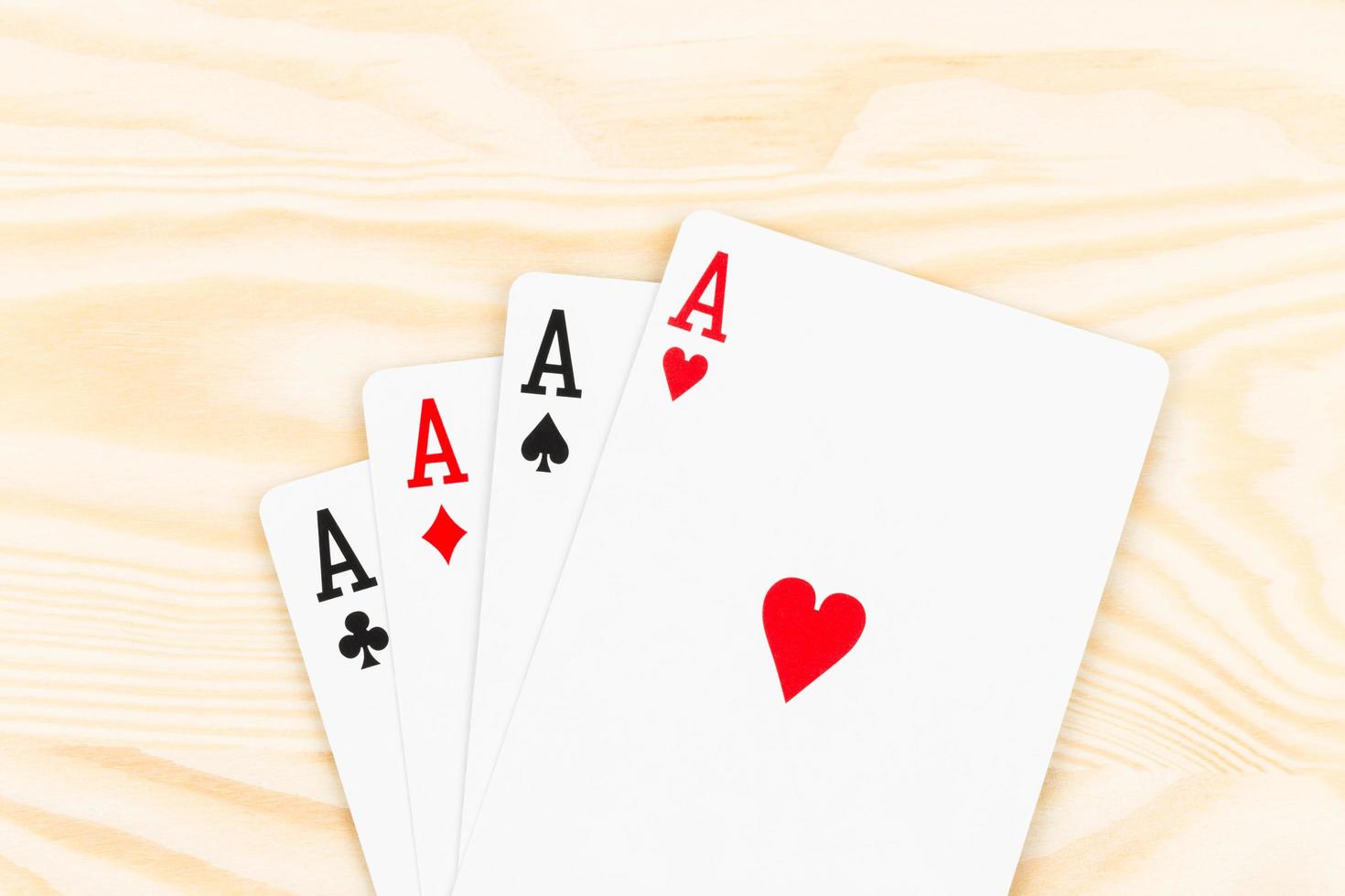 Four aces on wooden background photo