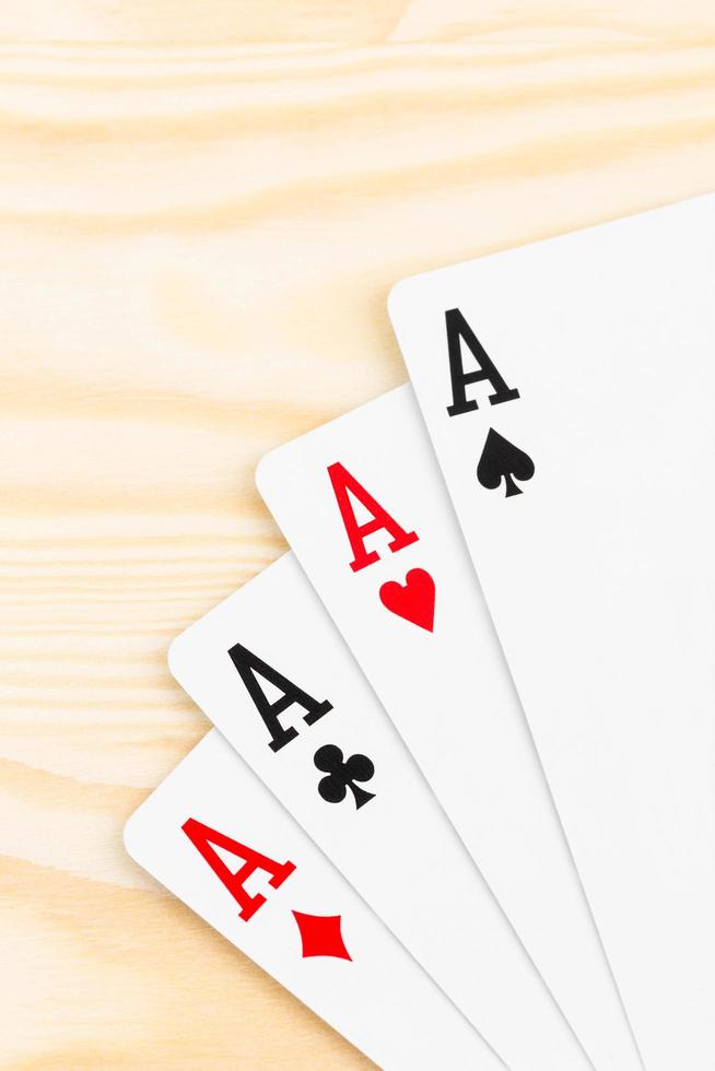 Four aces on wooden background photo