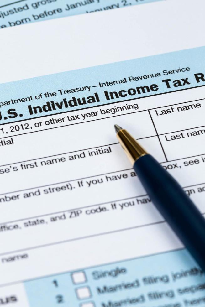 Tax form with pen taxation concept photo