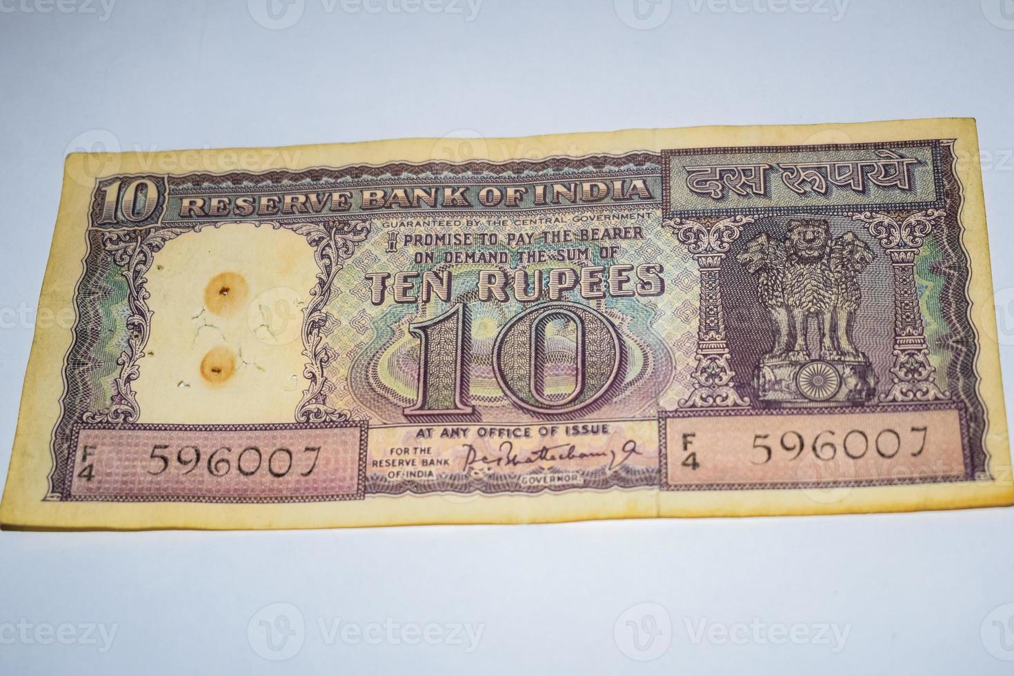 Rare Old Indian Ten rupee currency note on white background, Government of India ten rupee old banknote Indian currency, Old Indian Currency note on the table photo