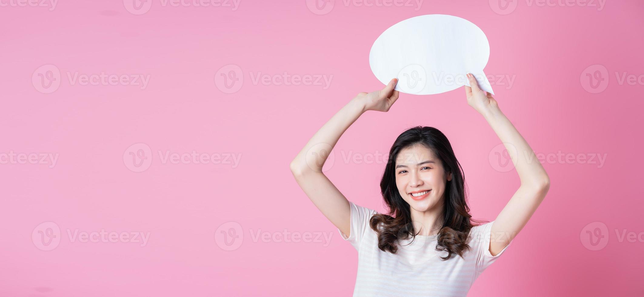 Image of young Asian woman holding message bubble on link background photo