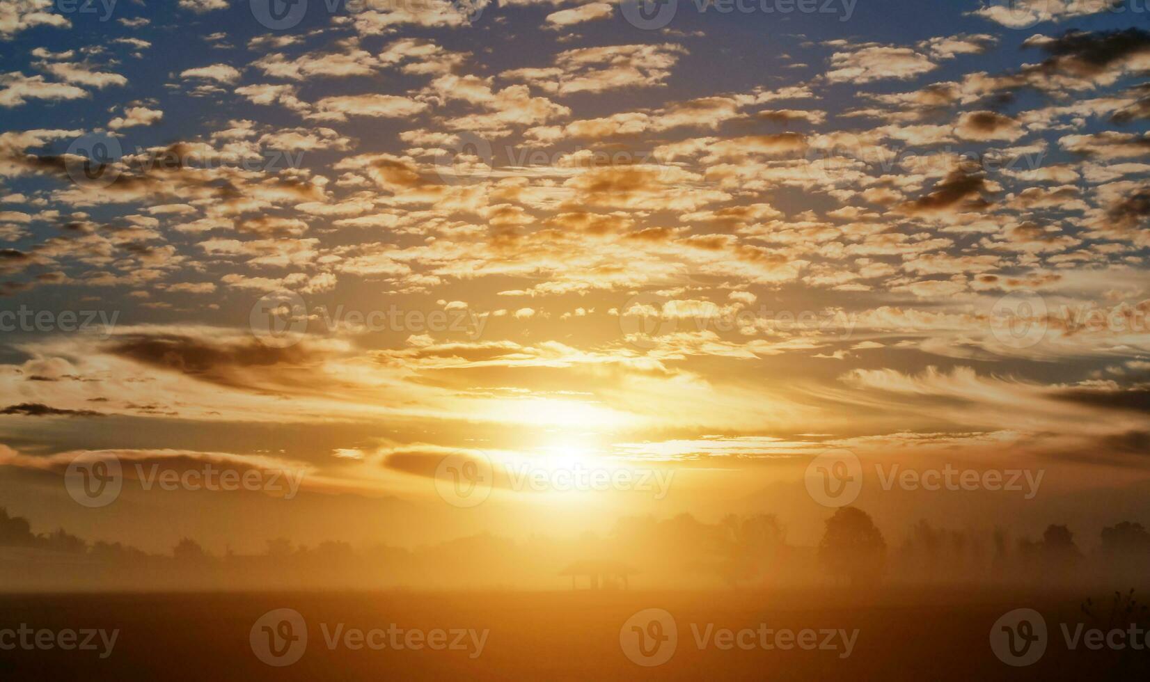 Countryside landscape under scenic colorful sky with flock of birds at sunset background. photo