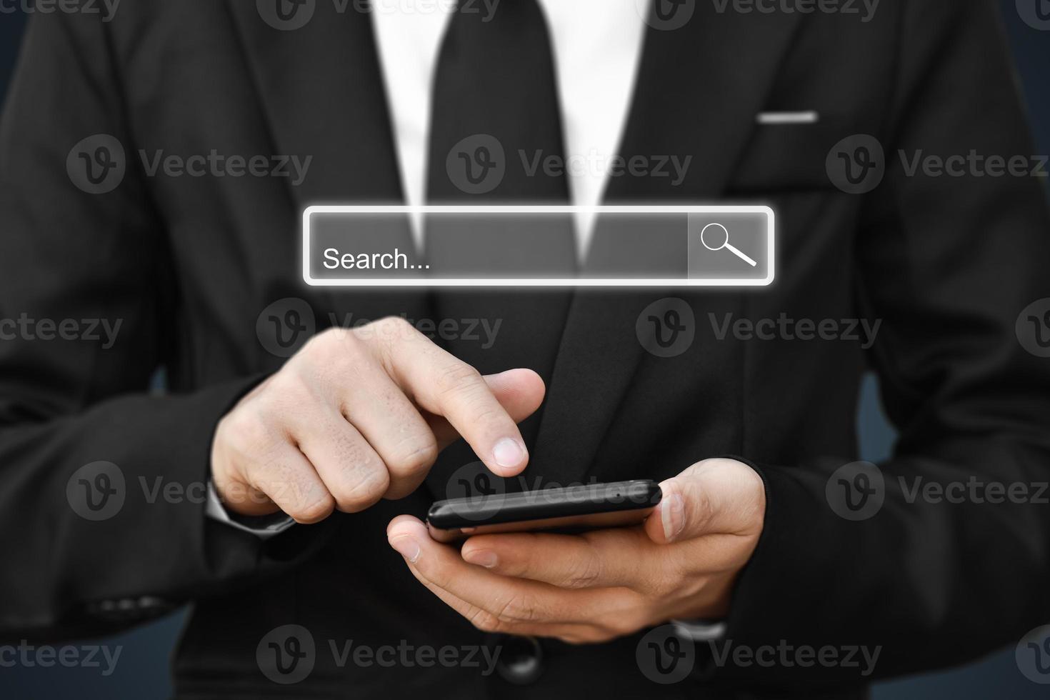 Businessman using smartphone to find information. Concept of search data on internet network. photo